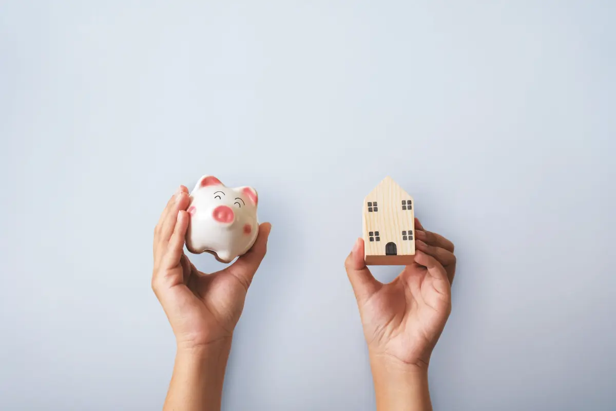 hands-holding-piggy-bank-small-wooden-house-concept-savings-property-investment_ret__ Immobilie verkaufen