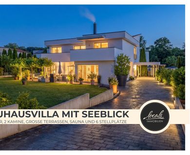 Ein Haus wie ein Rückzugsort: Exklusive Bauhausvilla mit Seeblick, Kaminatmosphäre und Traumgarten